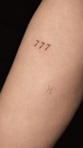 Close up to an arm with a tattoo 777