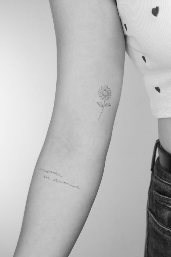 black and white Close up to an arm with a rose in minimal drawing style